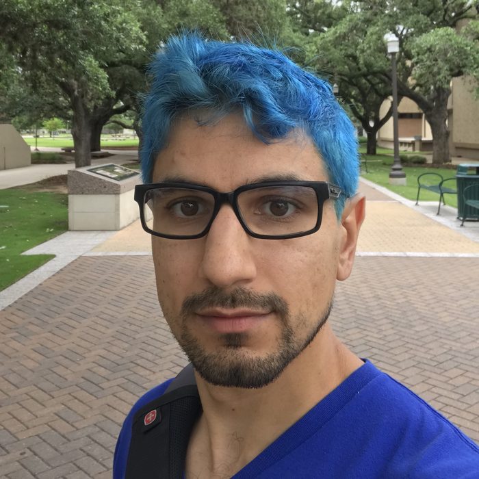 Kenny Easwaran in 2018, with blue hair, on the Texas A&M campus
